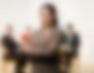 A blurry picture of people sitting at tables