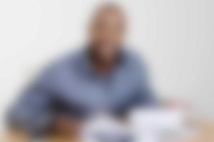 A blurry picture of a man sitting at a table