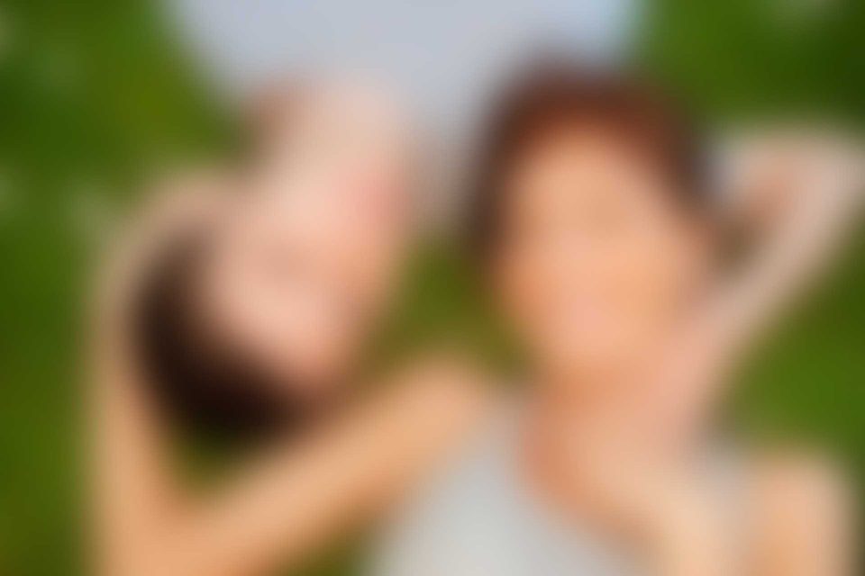 Two people are holding their heads together in a blurry picture.