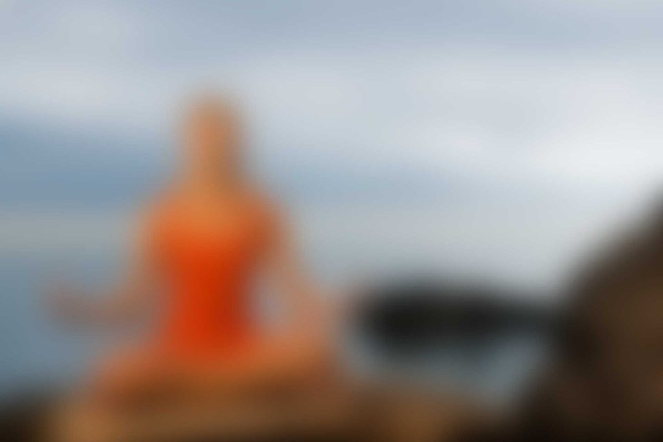 A blurry picture of an orange statue in the foreground.