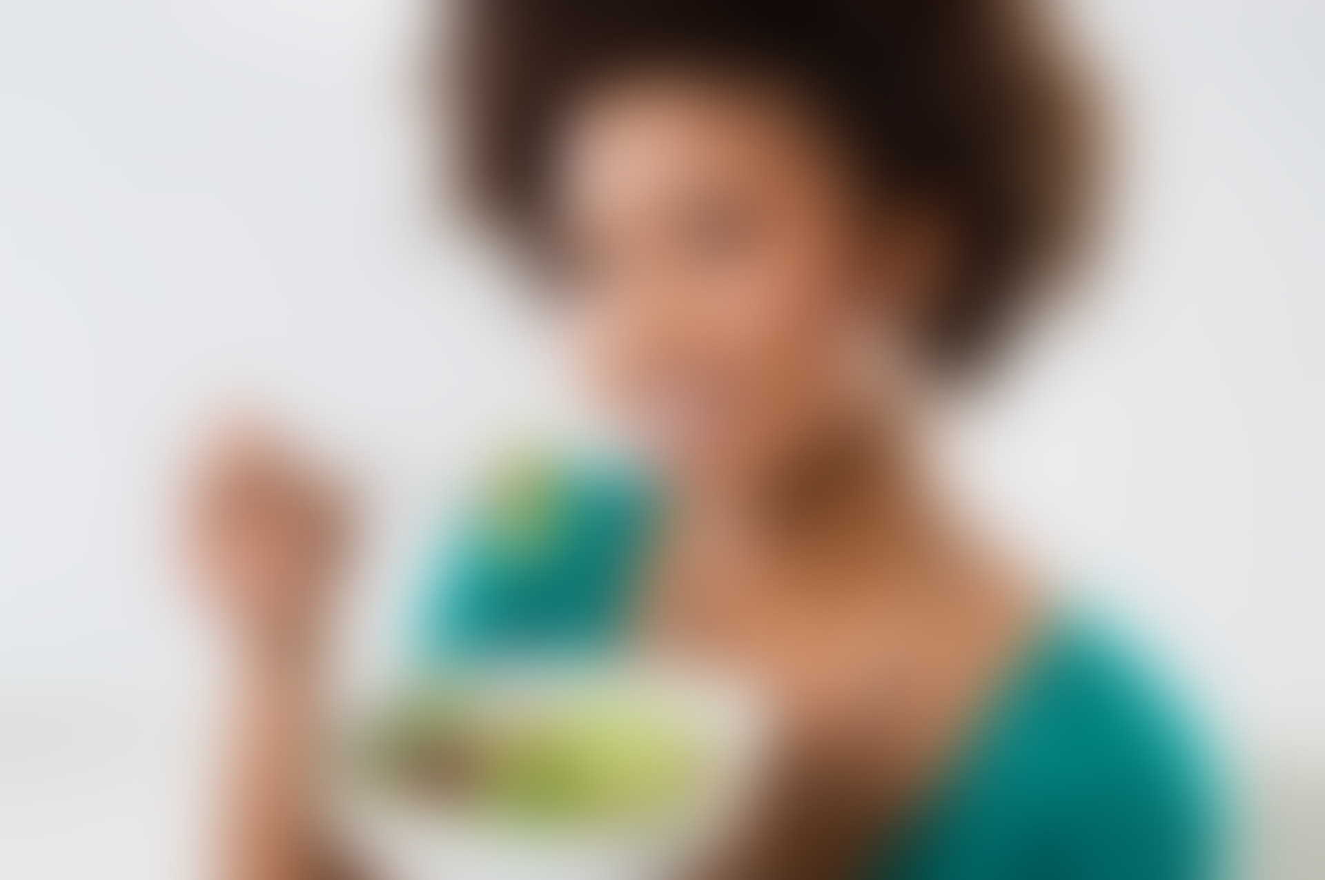 A blurry picture of a woman holding a bowl