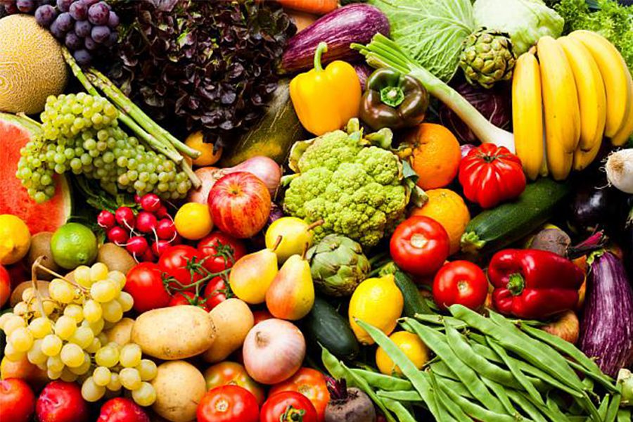 A pile of fruits and vegetables sitting on top of each other.