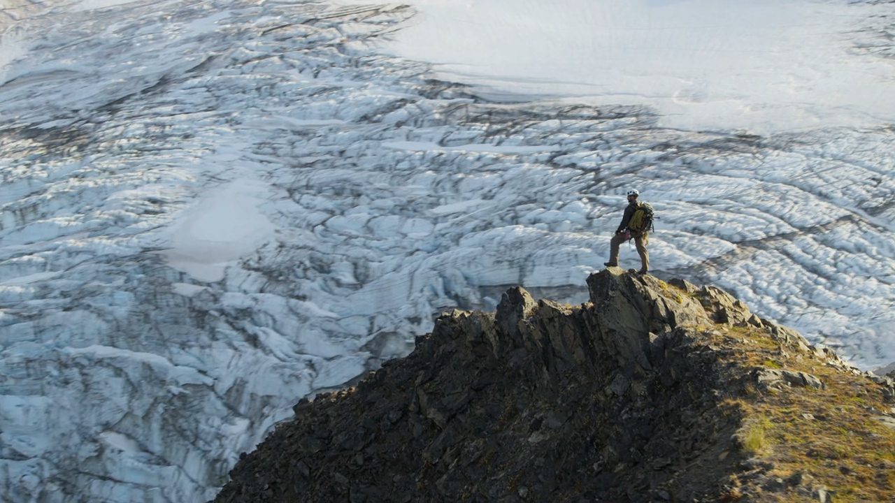 A person standing on top of a mountain.